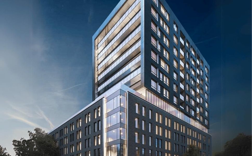 Modern residential building in Montreal illuminated at night with glass facade and contemporary design