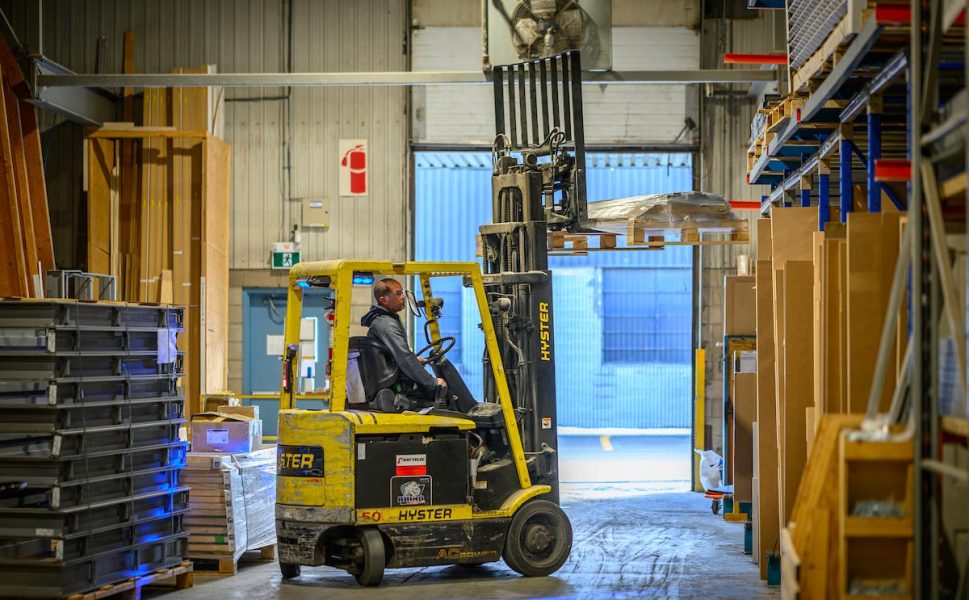 Portes Saint-Michel worker operating forklift in the door manufacturing warehouse