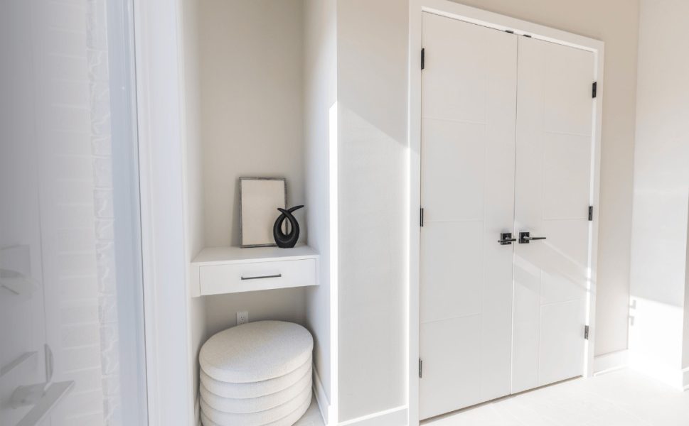 Modern white double interior door with black handles in contemporary home design