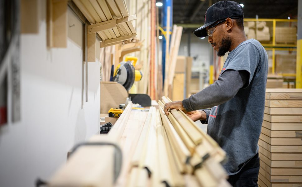 Portes Saint-Michel worker assembling wooden parts for door manufacturing